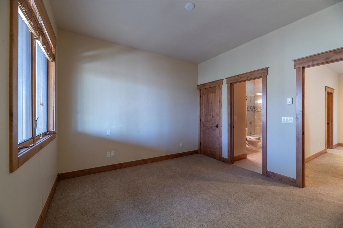 2206 Hamilton Creek Road Silverthorne, CO 80498 - Photo 29 of 39 Unfurnished bedroom featuring ensuite bath and light colored carpet