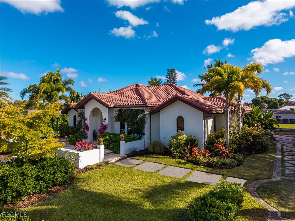 1971 Mitchell Avenue Alva, FL 33920 - Photo 1 of 50 a front view of a house with a yard and potted plants