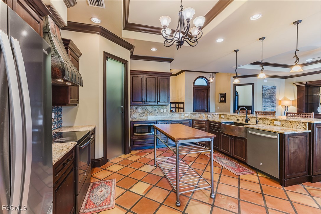 1971 Mitchell Avenue Alva, FL 33920 - Photo 19 of 50 a kitchen with stainless steel appliances granite countertop a sink a stove and a refrigerator