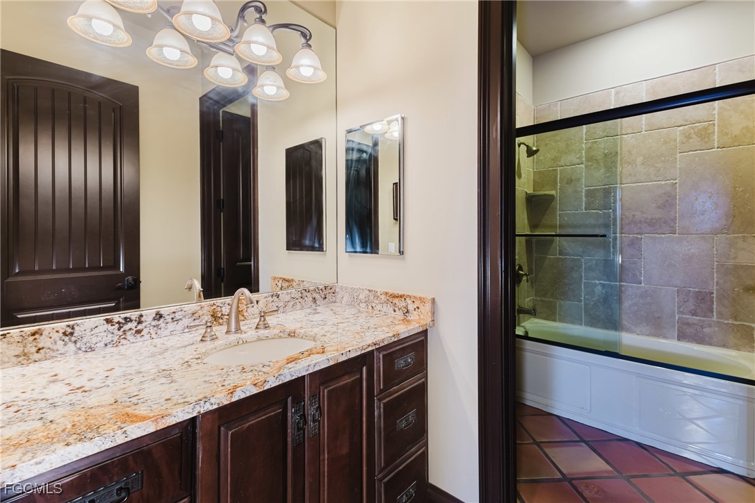 1971 Mitchell Avenue Alva, FL 33920 - Photo 27 of 50 a bathroom with a granite countertop sink a large mirror and a shower