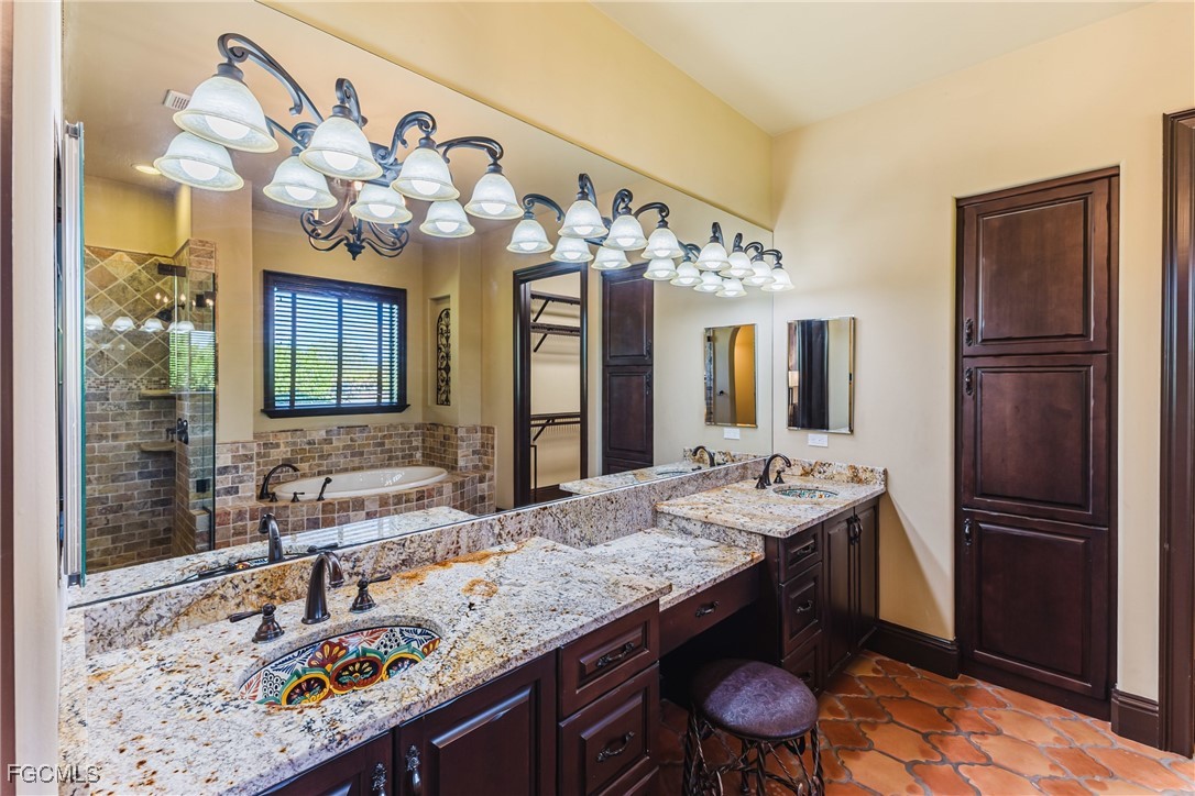 1971 Mitchell Avenue Alva, FL 33920 - Photo 31 of 50 a bathroom with a granite countertop sink a large mirror and a shower