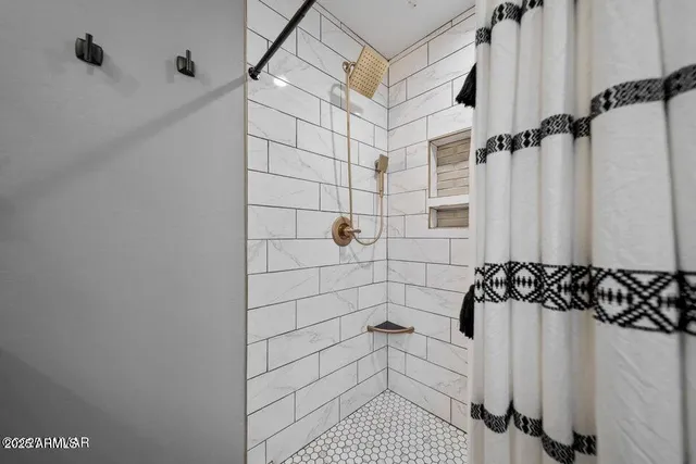 a bedroom with a large bed and a chandelier