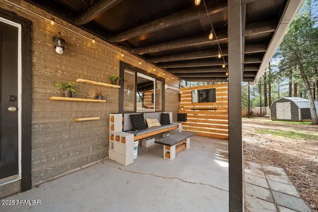 a backyard of a house with barbeque oven table and chairs