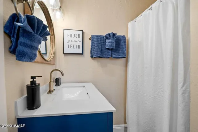 a white house covered with tall trees