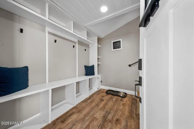 a very nice looking living room with a dining table chairs with wooden floor