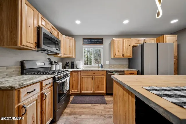 a bedroom with a bed and large windows