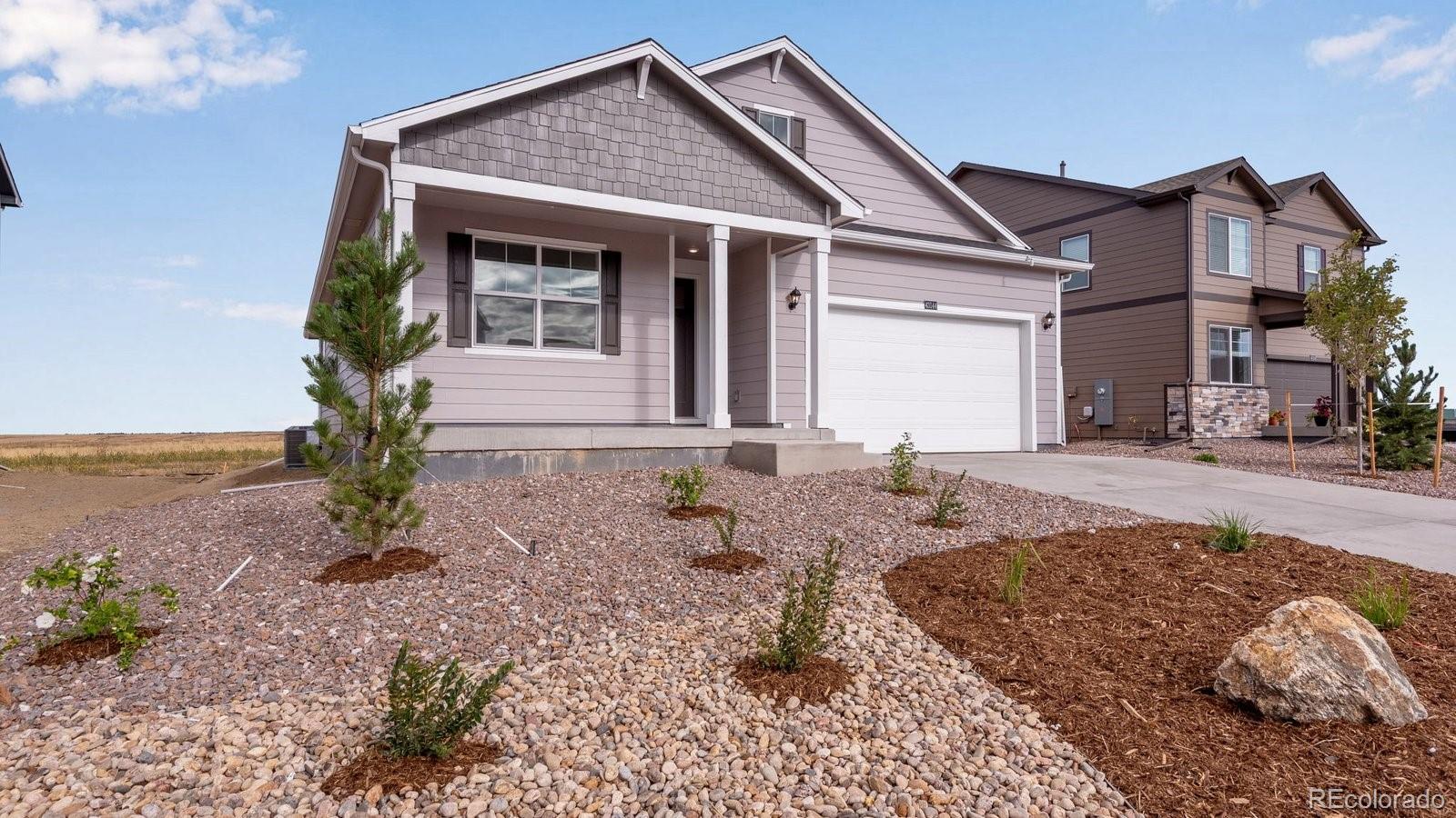 4889 Lynxes Way Johnstown, CO 80534 - Photo 2 of 28 a front view of a house with garden
