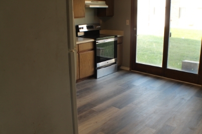 2902 31st Street, Unit 6 Zion, IL 60099 - Photo 5 of 7 a kitchen with granite countertop a stove and a window