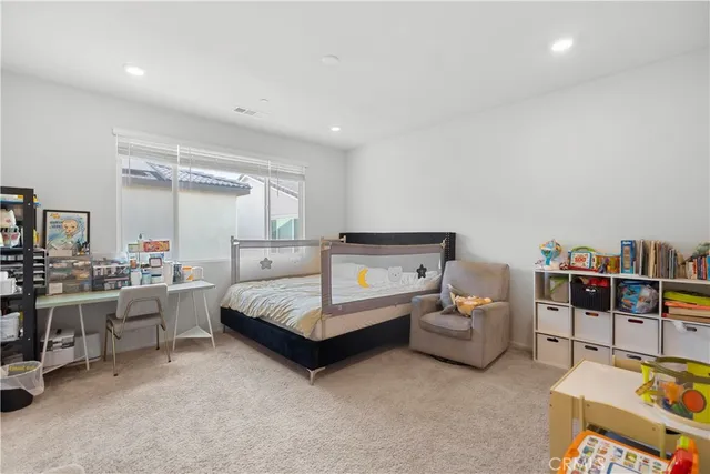 a bedroom with furniture and white walls