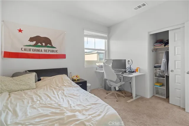 a bedroom with a bed and a desk