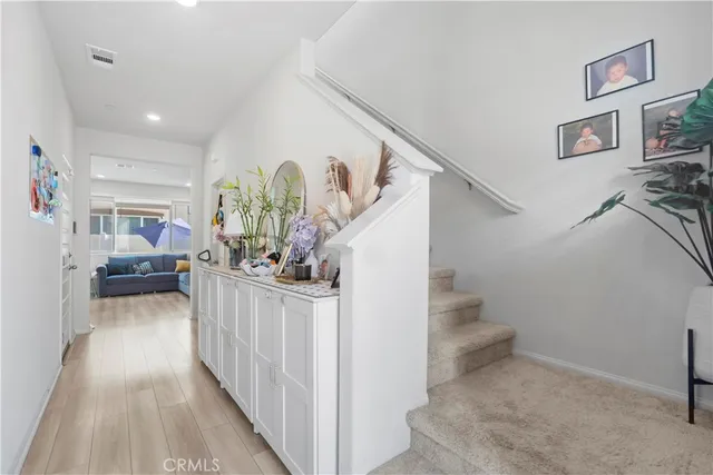 a view of entryway and hall with wooden floor
