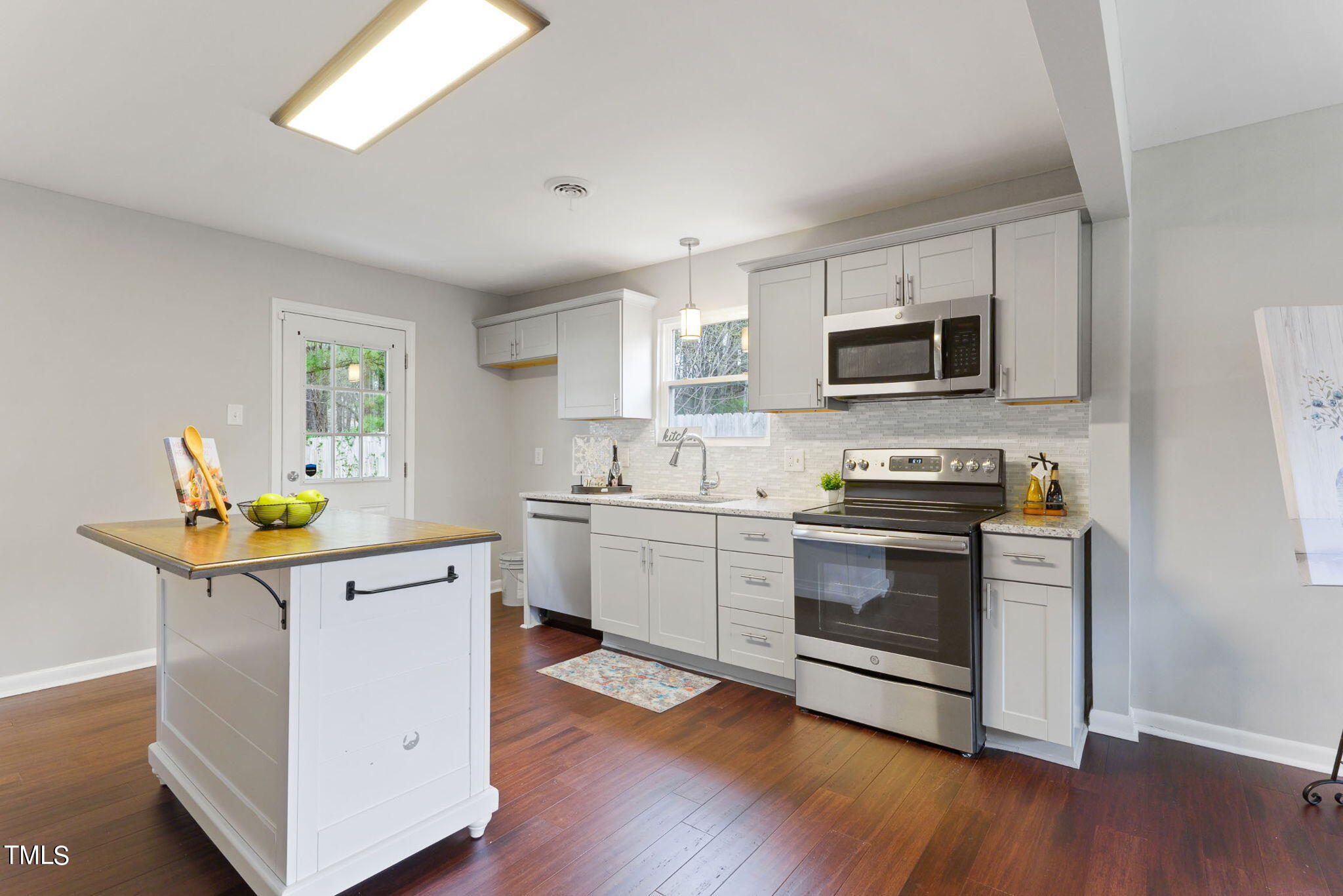 1005 Delray Street Durham, NC 27713 - Photo 3 of 18 a kitchen with stainless steel appliances a stove microwave and sink