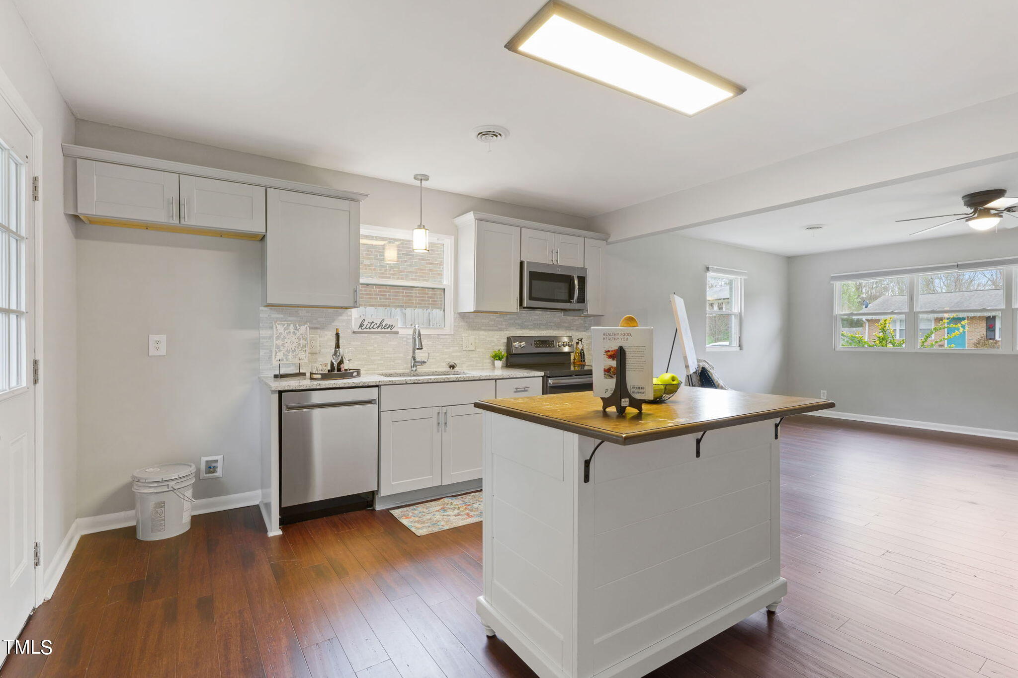 1005 Delray Street Durham, NC 27713 - Photo 5 of 18 a kitchen with sink cabinets and wooden floor