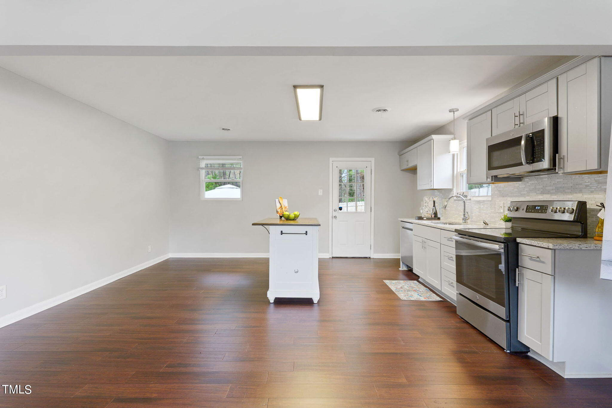 1005 Delray Street Durham, NC 27713 - Photo 6 of 18 a kitchen with a refrigerator and a stove top oven
