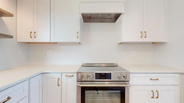 a kitchen with stainless steel appliances kitchen island hardwood floor sink and stove