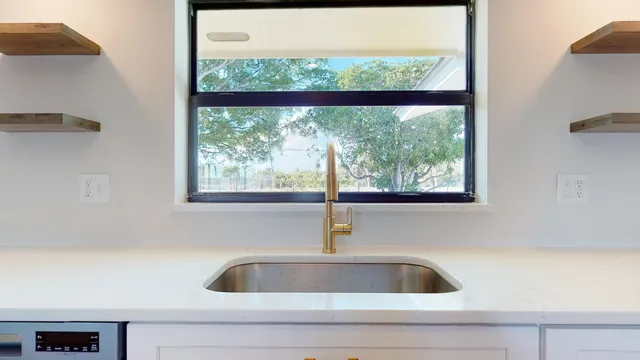 a kitchen with stainless steel appliances a refrigerator sink and cabinets