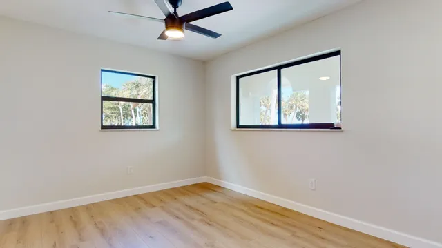 a view of a room with wooden floor and outer view