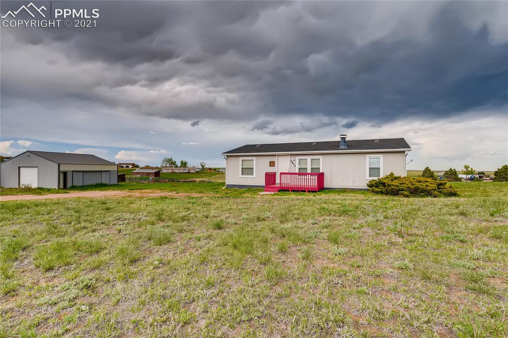 5855 Prospero Road Peyton, CO 80831 - Photo 1 of 11 Front of Home with View of Garage/Barn