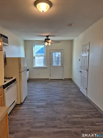 a view of a kitchen with a sink dishwasher oven window and wooden floor