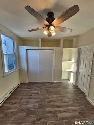 a view of a livingroom with a ceiling fan and wooden floor