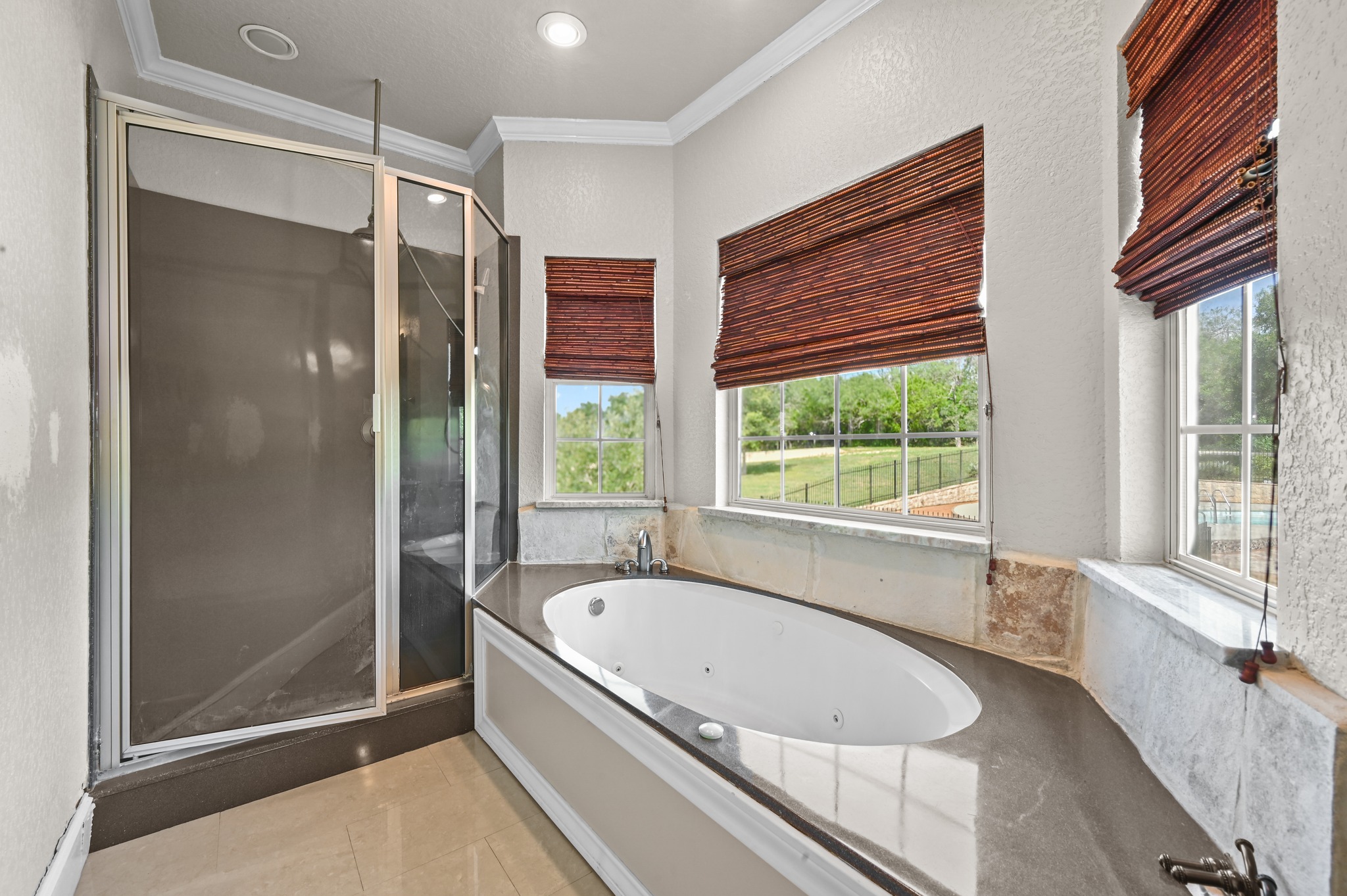 1175 Southern Way Luling, TX 78648 - Photo 28 of 40 Indulge in relaxation with a spacious soaking tub and an adjacent shower, complemented by natural light and serene views.