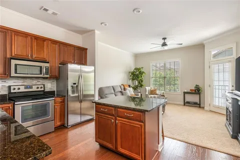 a kitchen with sink stove and refrigerator