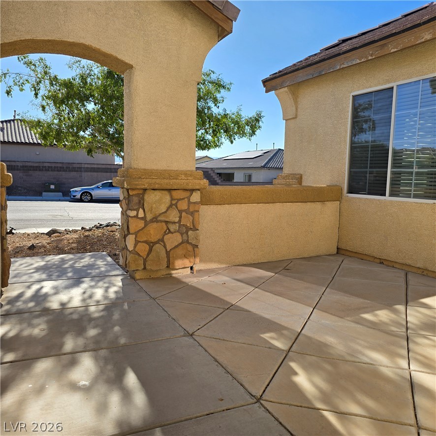 9234 Kingston Road Henderson, NV 89074 - Photo 7 of 38 A welcoming front patio with stone accents offers a charming entryway to this residence.