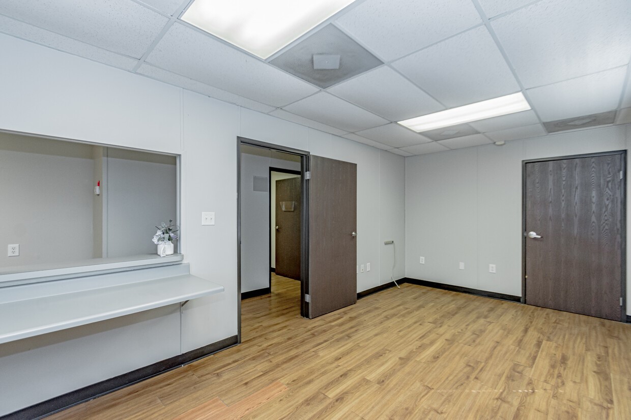 3373 East Highway 6 Alvin, TX 77511 - Photo 13 of 28 a view of an empty room with wooden floor and a window