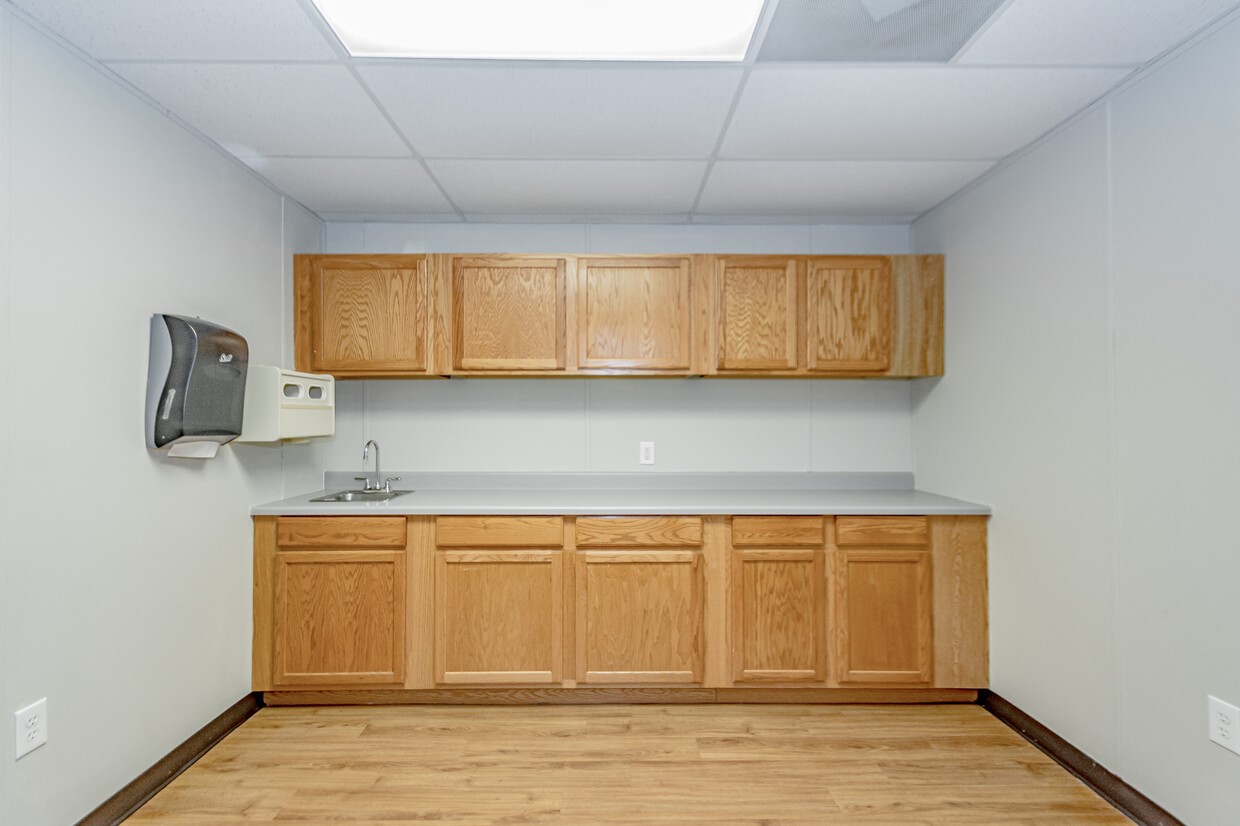 3373 East Highway 6 Alvin, TX 77511 - Photo 15 of 28 a view of a kitchen with wooden floor and cabinets