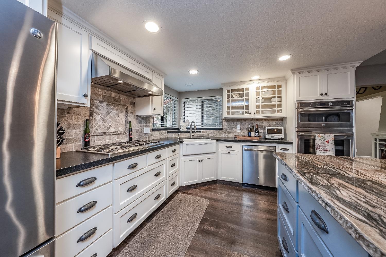 28 Seasons Court Madera, CA 93637 - Photo 11 of 47 a kitchen with granite countertop kitchen island wooden cabinets and stainless steel appliances