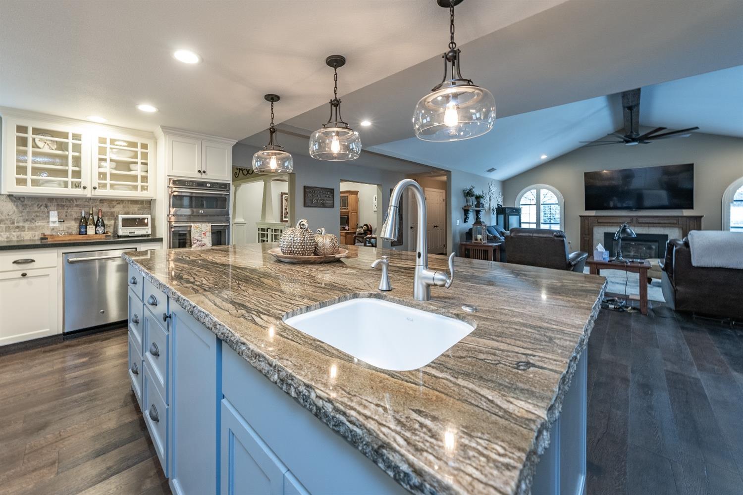 28 Seasons Court Madera, CA 93637 - Photo 12 of 47 a kitchen with granite countertop a stove a sink a oven a dining table and chairs