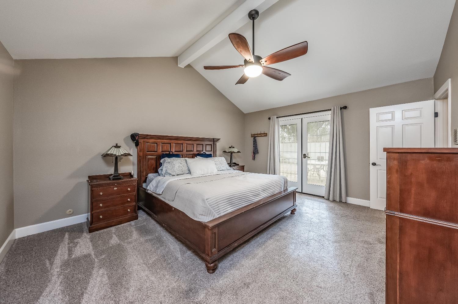 28 Seasons Court Madera, CA 93637 - Photo 19 of 47 a bedroom with a bed and a chandelier