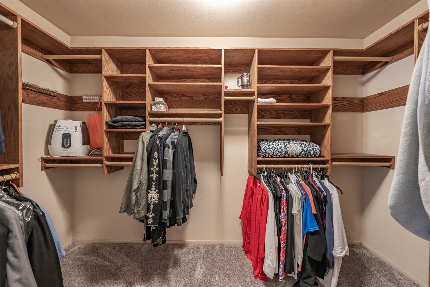 28 Seasons Court Madera, CA 93637 - Photo 23 of 47 a view of walk in closet with clothes and shoes
