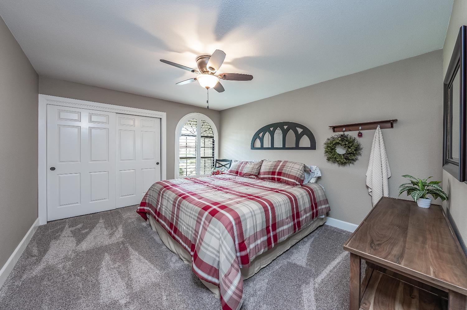28 Seasons Court Madera, CA 93637 - Photo 28 of 47 a bed sitting in a bedroom next to a window