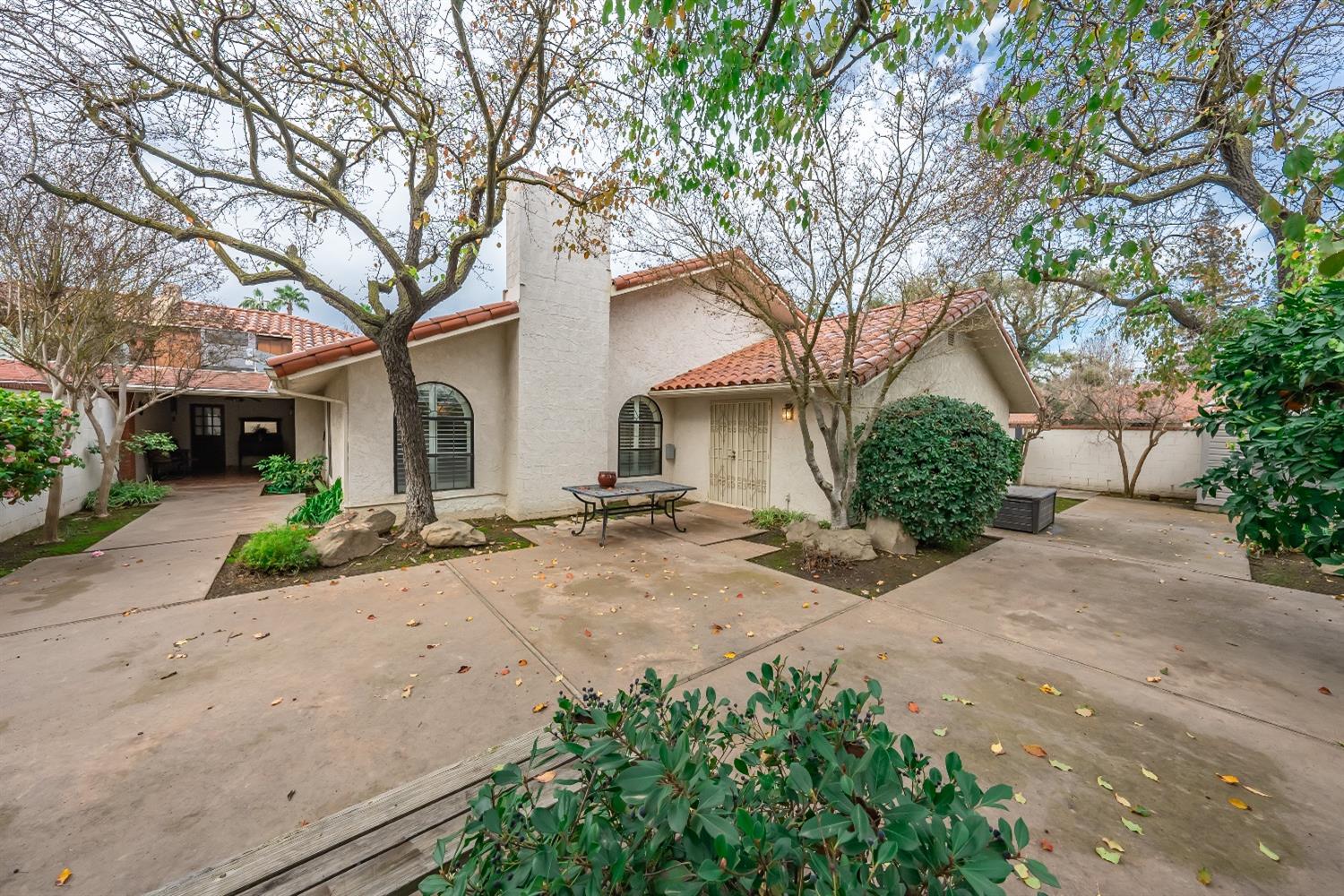 28 Seasons Court Madera, CA 93637 - Photo 32 of 47 a front view of a house with a yard and potted plants