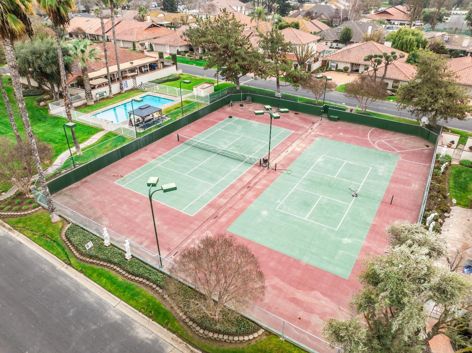 28 Seasons Court Madera, CA 93637 - Photo 46 of 47 a view of a tennis ground with a large trees