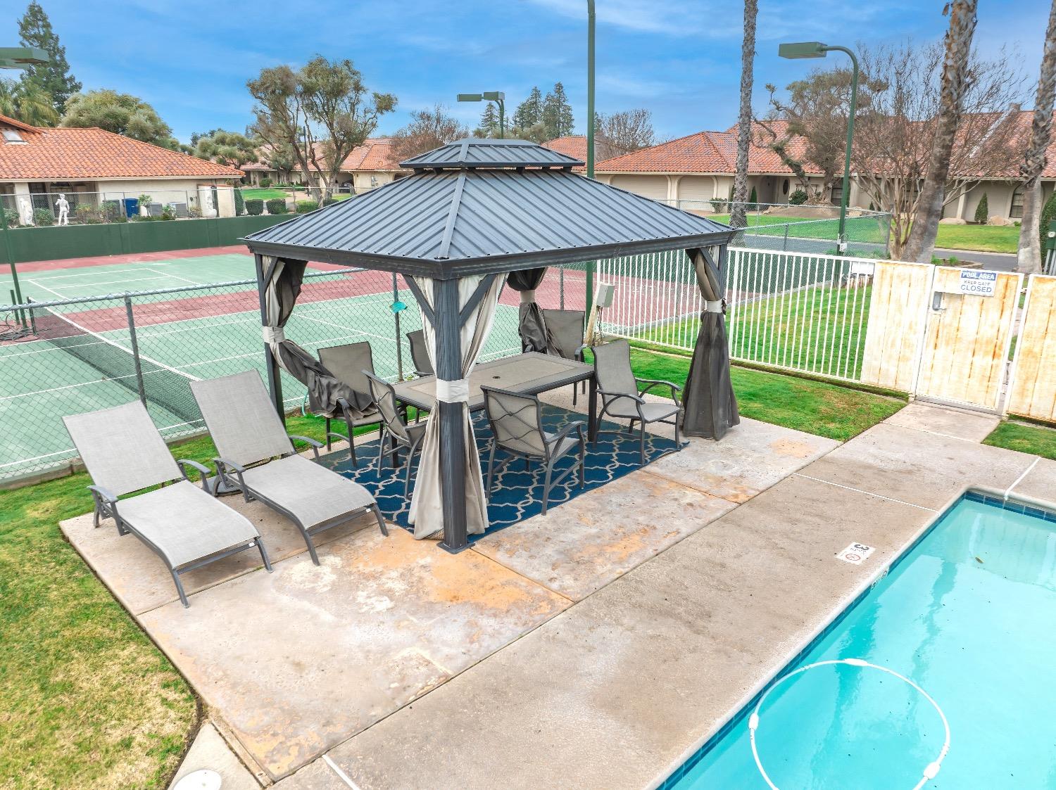 28 Seasons Court Madera, CA 93637 - Photo 47 of 47 an outdoor space with furniture and umbrella