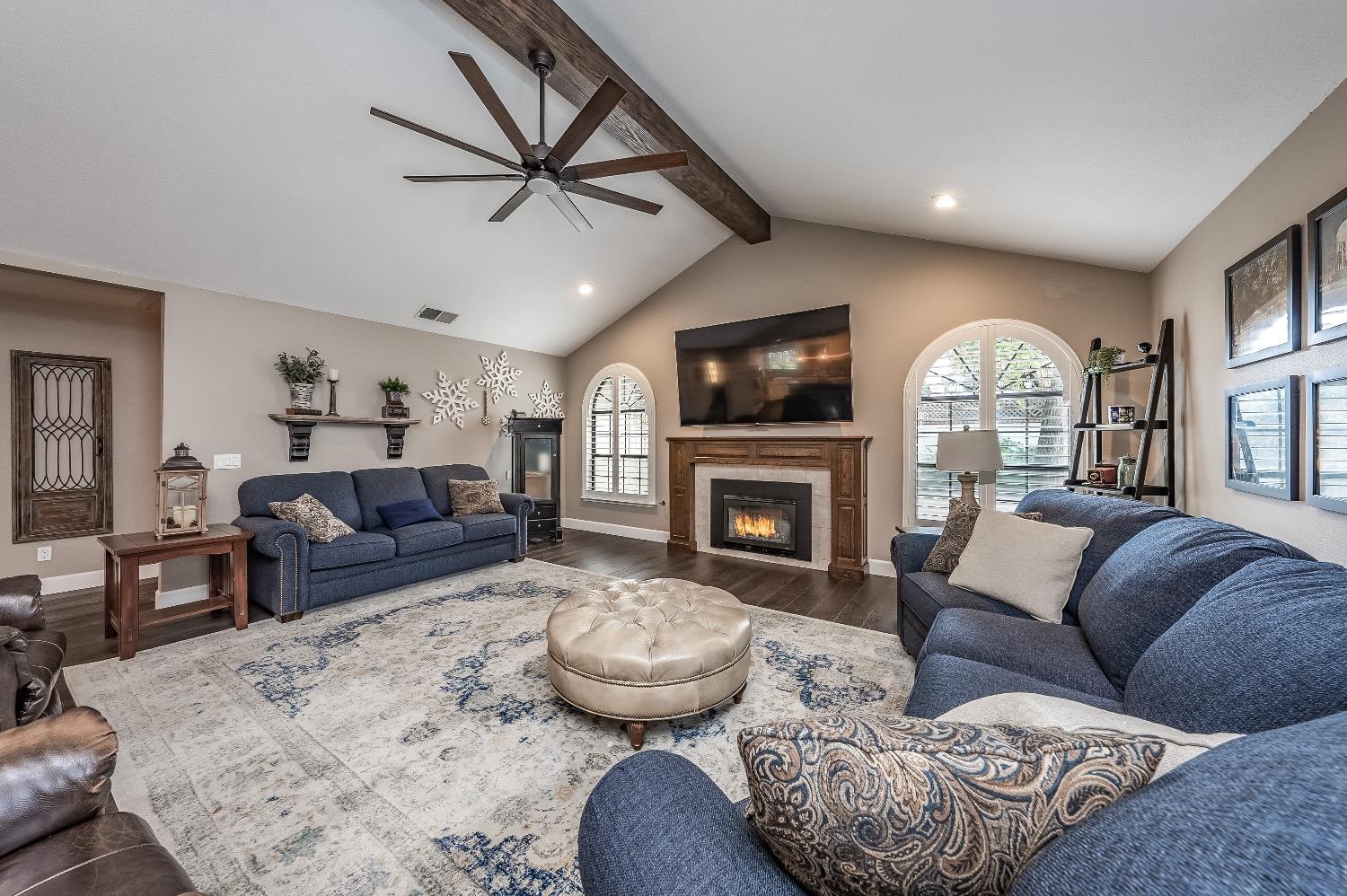 28 Seasons Court Madera, CA 93637 - Photo 7 of 47 a living room with furniture a fireplace and a flat screen tv