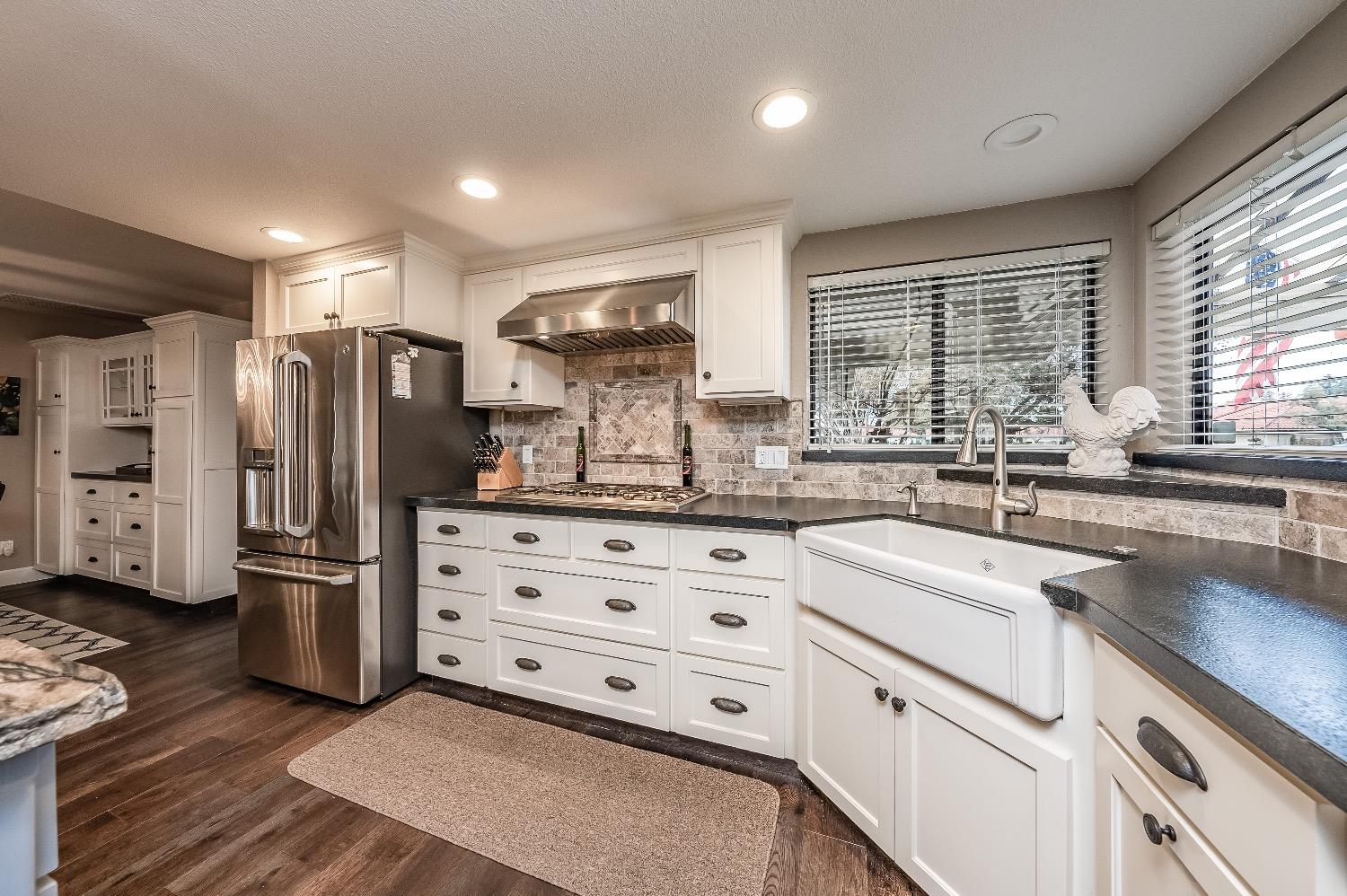 28 Seasons Court Madera, CA 93637 - Photo 9 of 47 a kitchen with refrigerator cabinets and large window