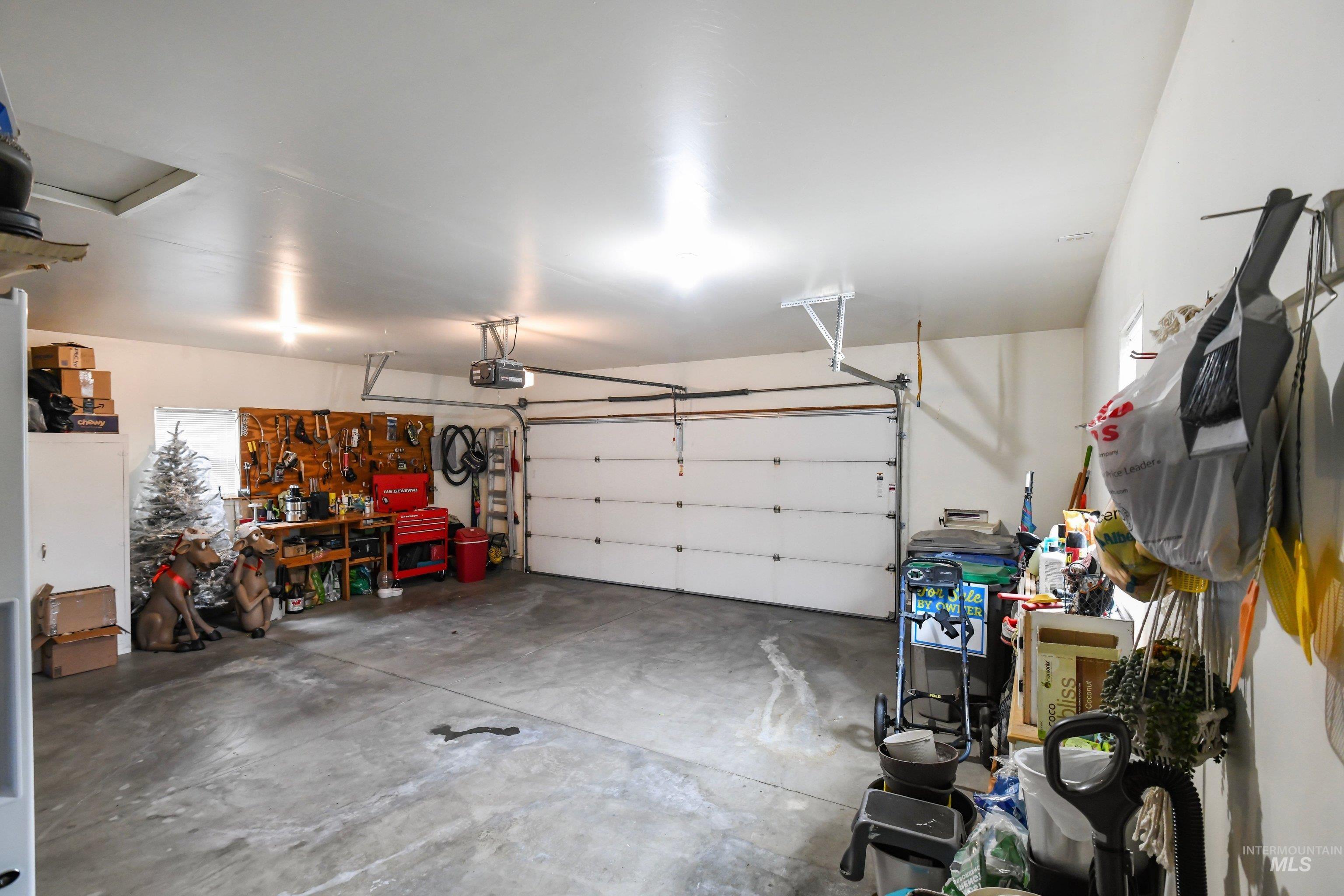 421 South Curtis Road, Unit 202 202 Boise, ID 83705 - Photo 21 of 41 Laundry area featuring wood-finish flooring, overhead white cabinetry, and a clothing rod