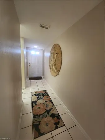 a kitchen with a table chairs and a refrigerator