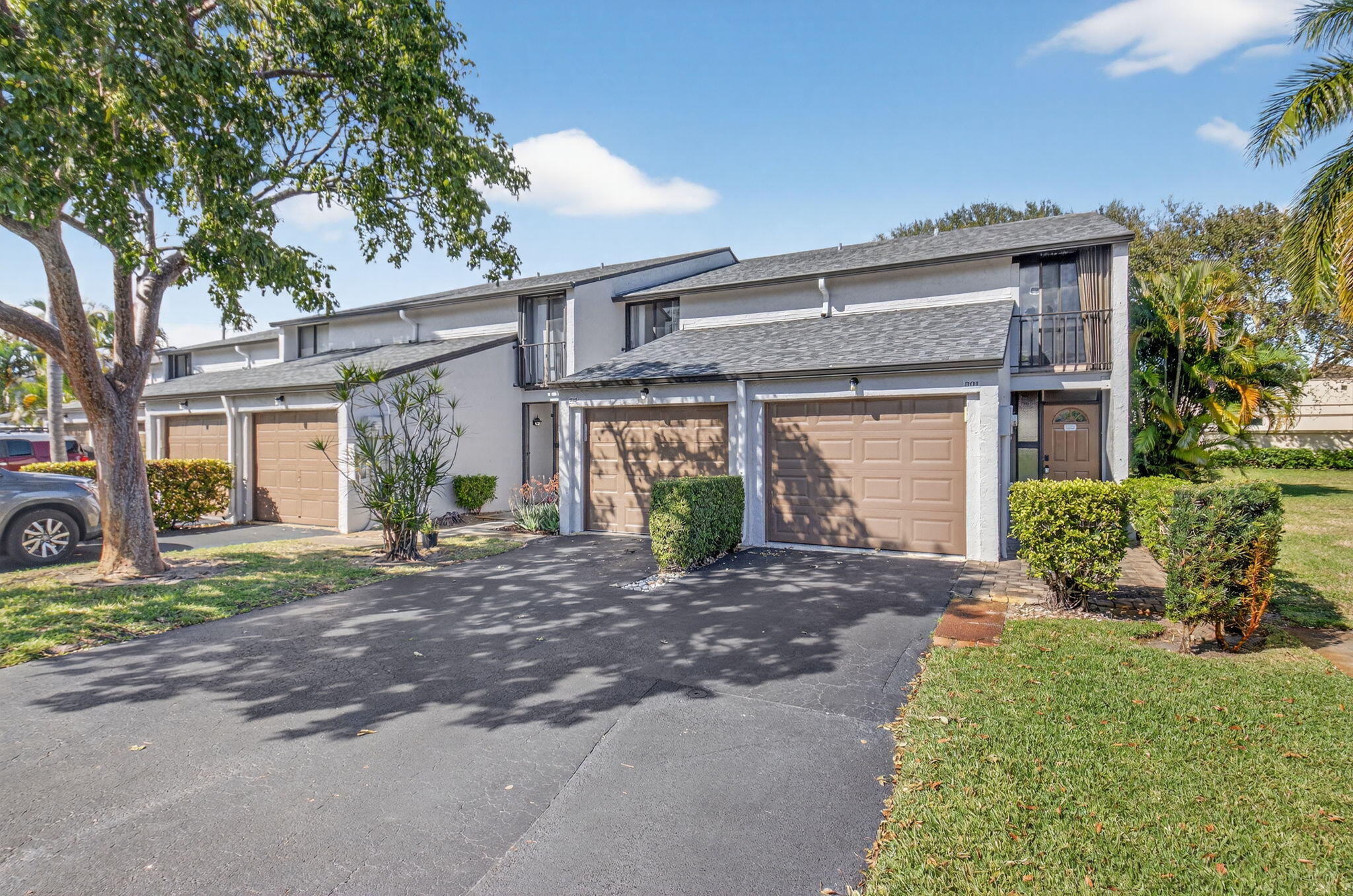 a front view of a house with a garden and outdoor seating