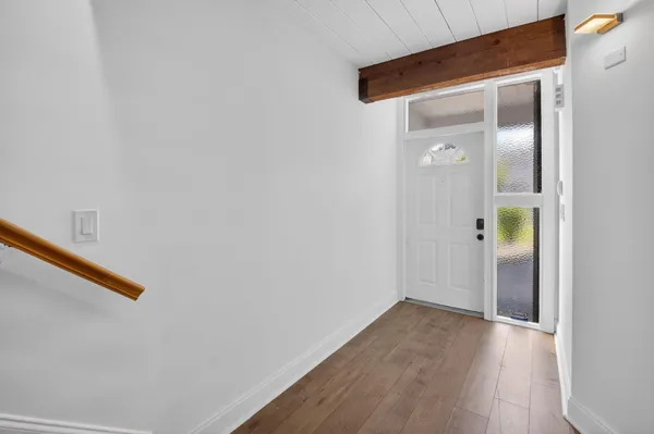 a view of a hallway with wooden floor
