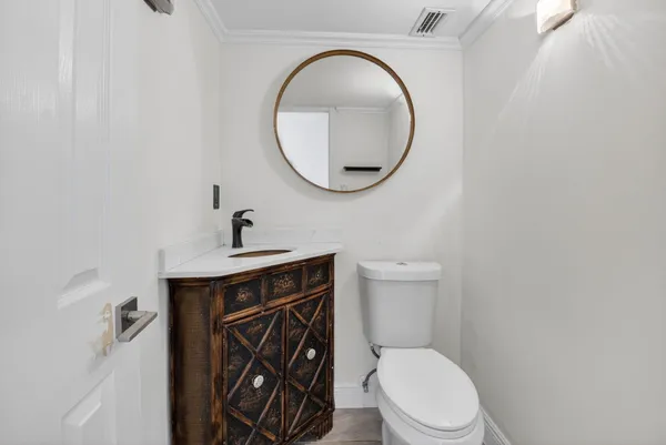a bathroom with a toilet a sink and a mirror