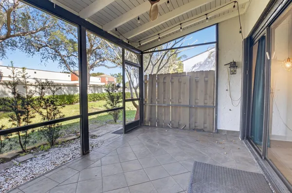 an empty room with sliding door and wooden floor