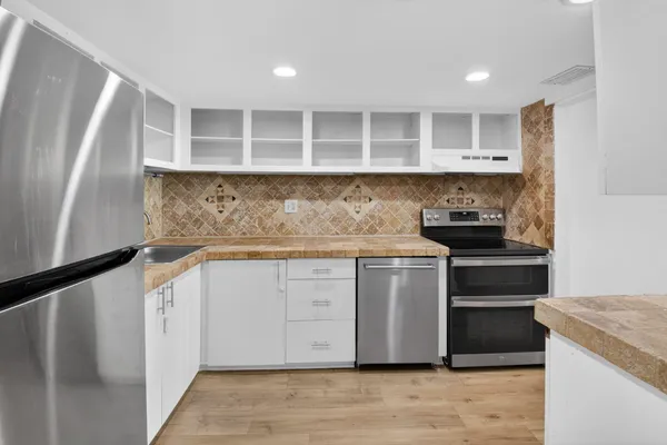 a kitchen with a stove and a refrigerator