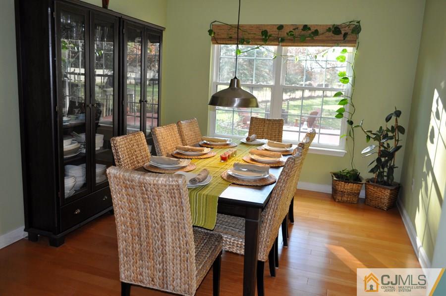 30 Smithwold Road Somerset, NJ 08873 - Photo 3 of 24 a dining room with furniture a chandelier and wooden floor