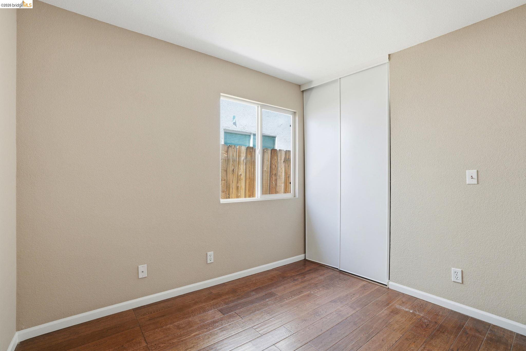 4465 Fall Lane Oakley, CA 94561 - Photo 11 of 26 a view of an empty room with wooden floor and a window