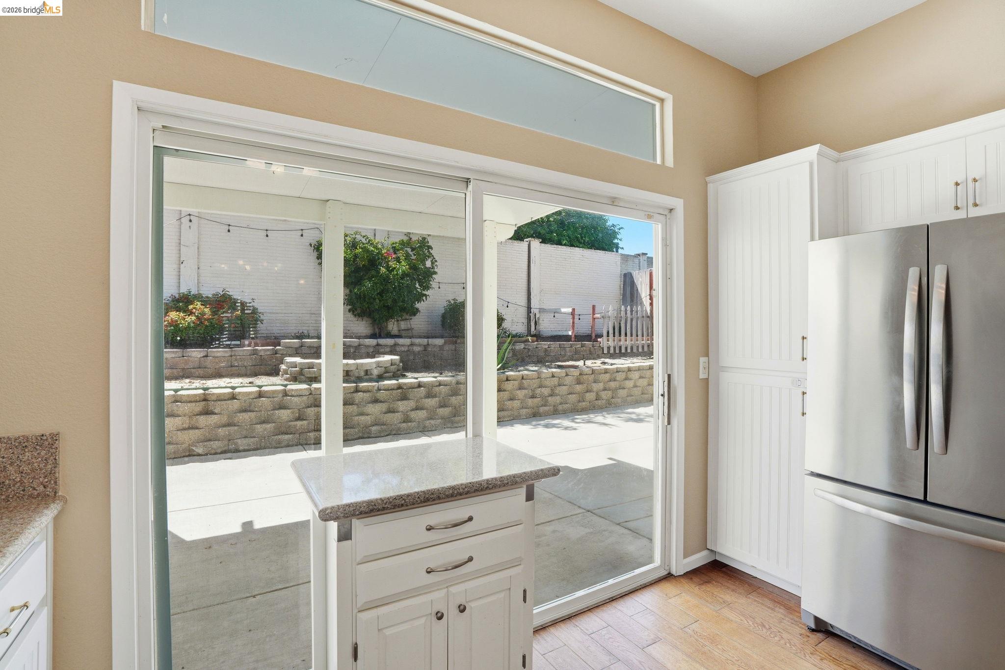 4465 Fall Lane Oakley, CA 94561 - Photo 18 of 26 a kitchen with a refrigerator a table and a large window
