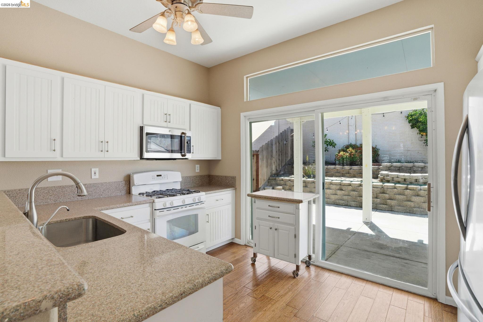 4465 Fall Lane Oakley, CA 94561 - Photo 2 of 26 a kitchen with a sink a stove and cabinets